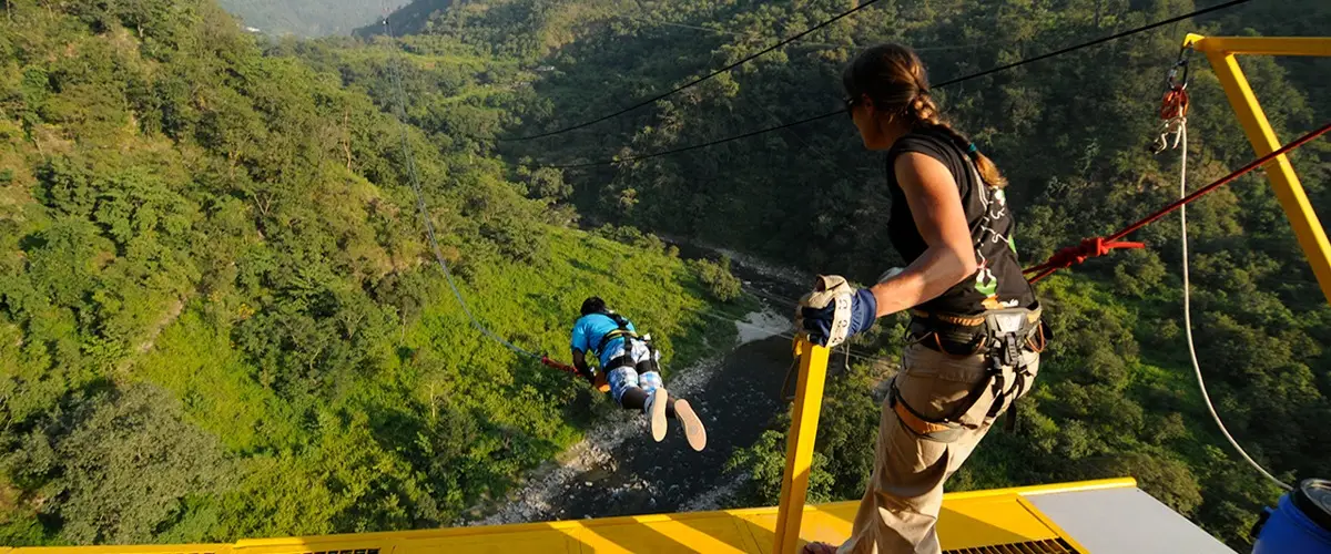 Person experiencing a Giant Swing over a valley in Rishikesh