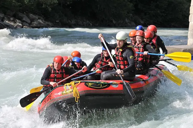 Group on a raft navigating rapids during River Rafting in Rishikesh
